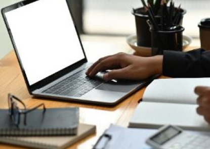 picture of a computer on a desk with someone beginning to type